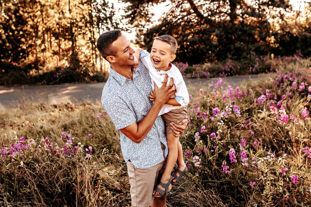 Father and son playing in wildflowers
