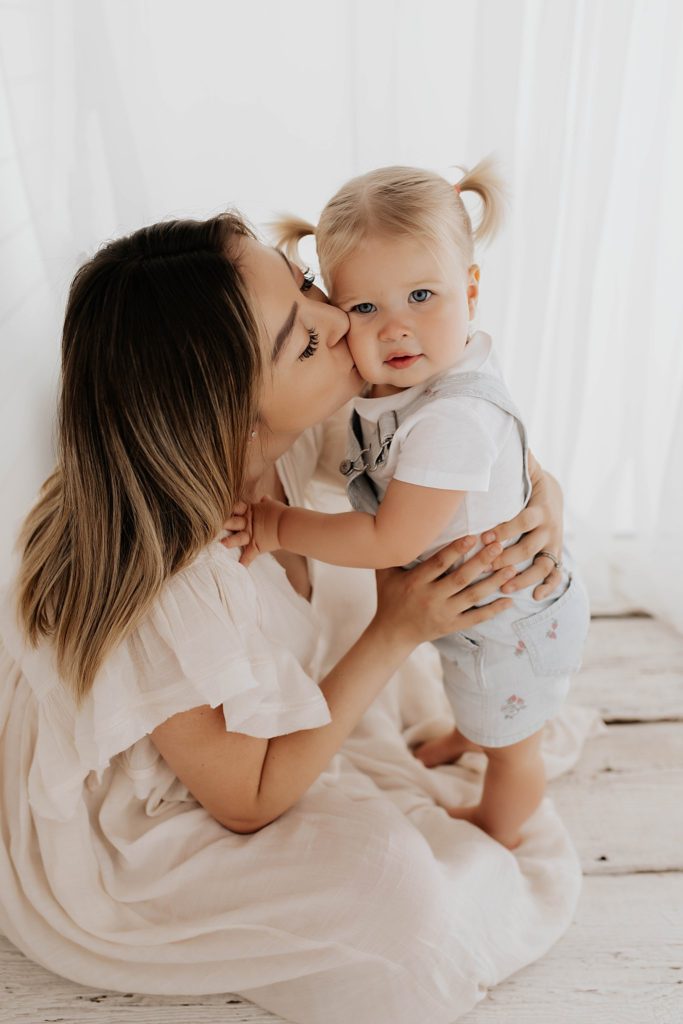 Toddler hugging pregnant mom with Seattle maternity photographer