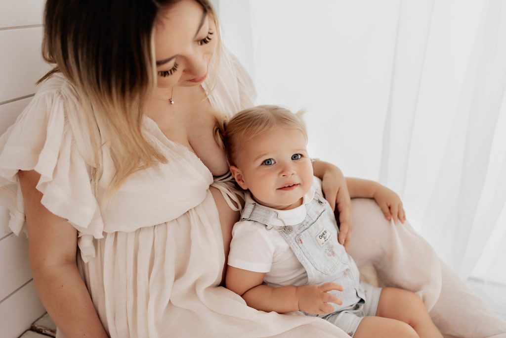 Toddler sitting on baby bump